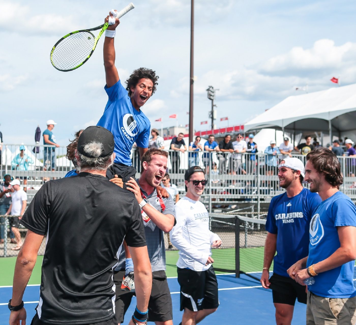 men lifting up a winning player