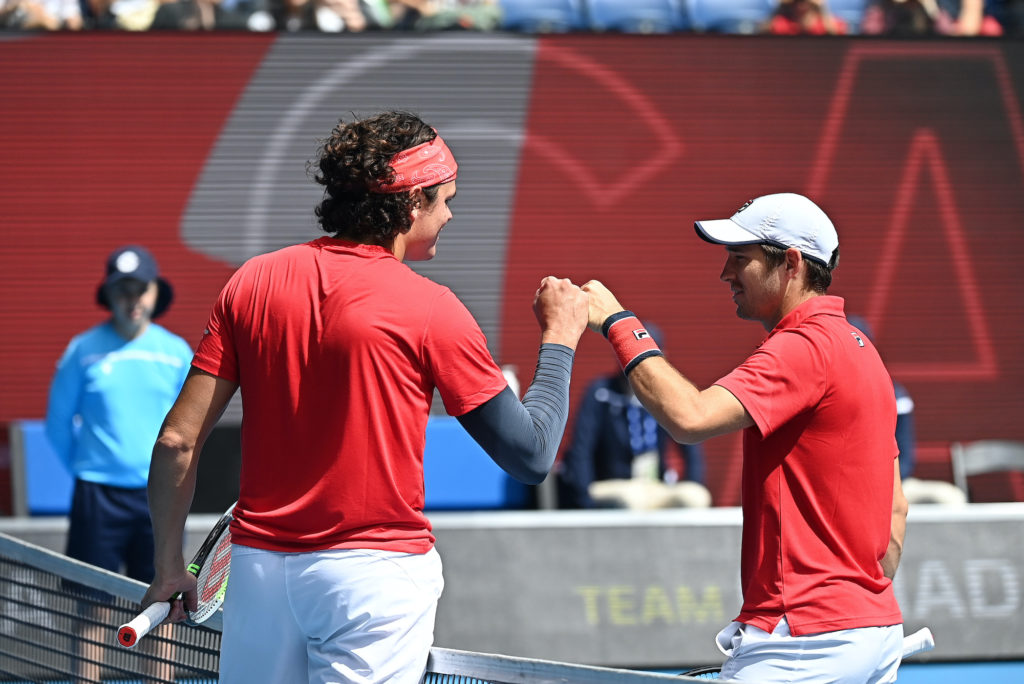 milos raonic fistbumps dusan lajovic after winning at the atp cup