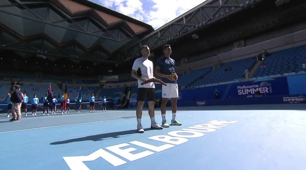 felix auger-aliassime stands with runner-up trophy