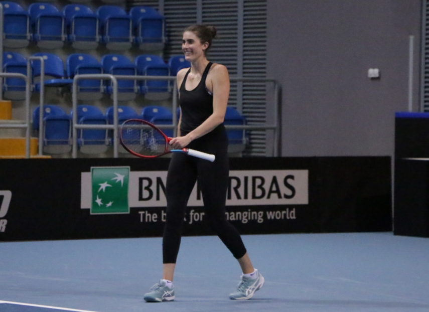 rebecca marino holding racquet in practice