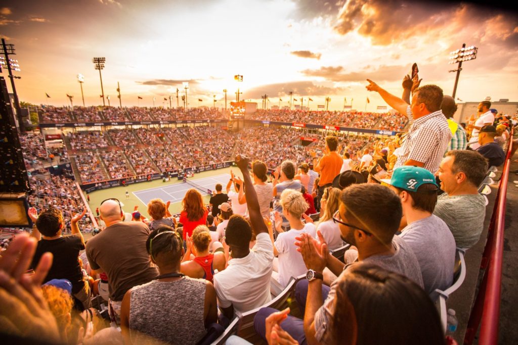 Sunset over a full IGA Stadium in Montreal, with people raising their arms in celebration