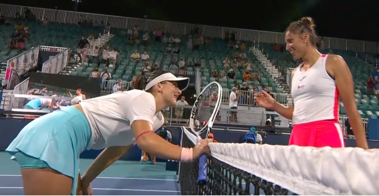 Bianca Andreescu smiles at Sara sorribes Tormo at the net after their match