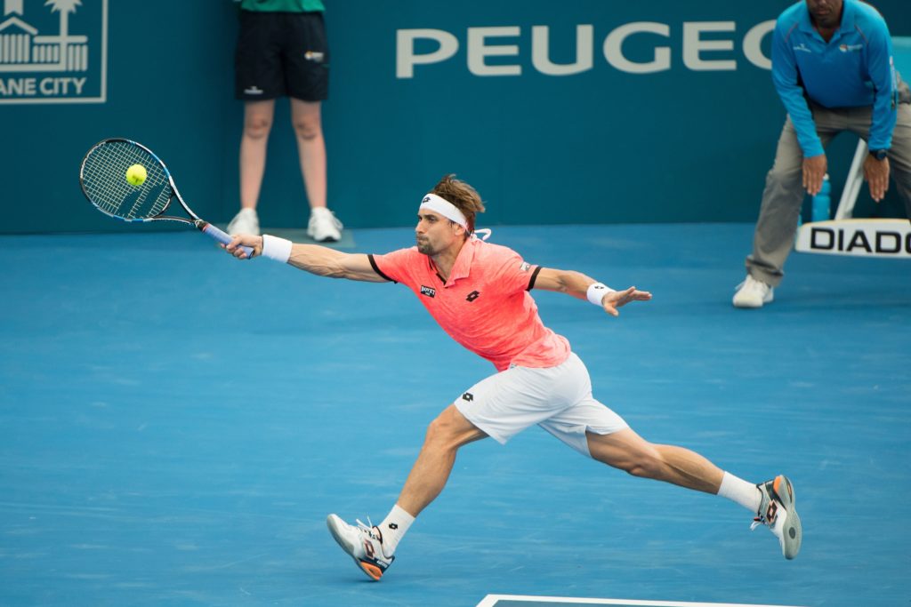 David Ferrer Chases a ball wide to his forehand on a hard court