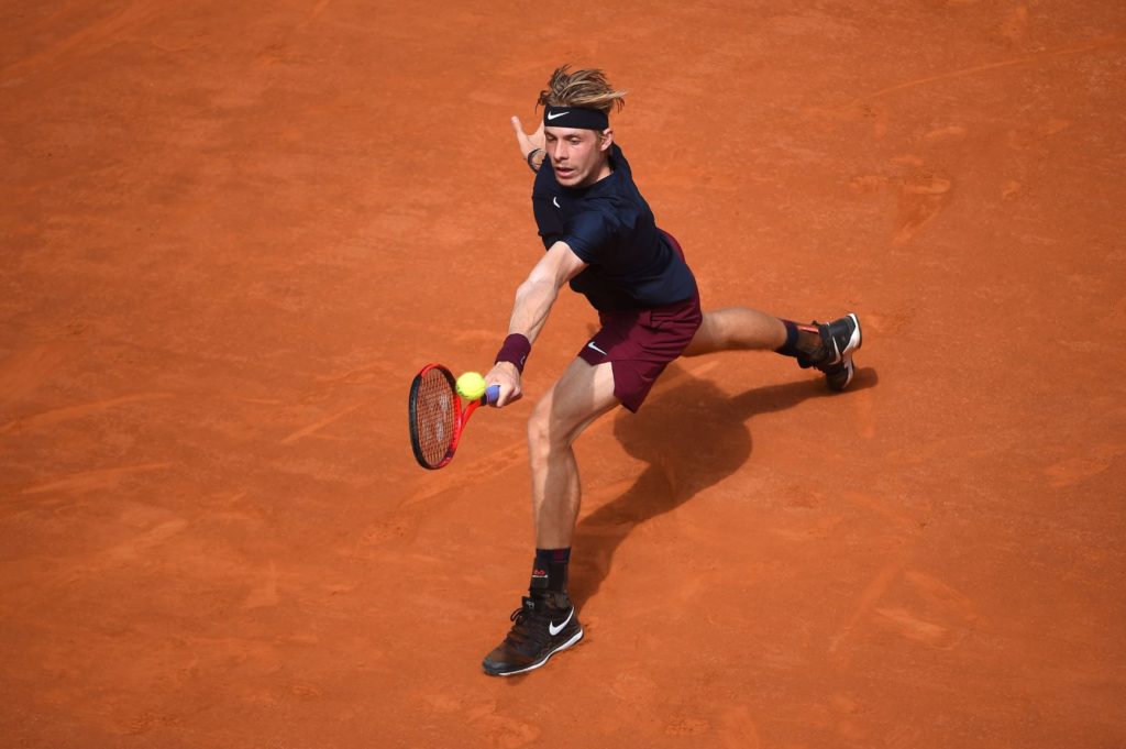 Denis Shapovalov stretches to hit a backhand
