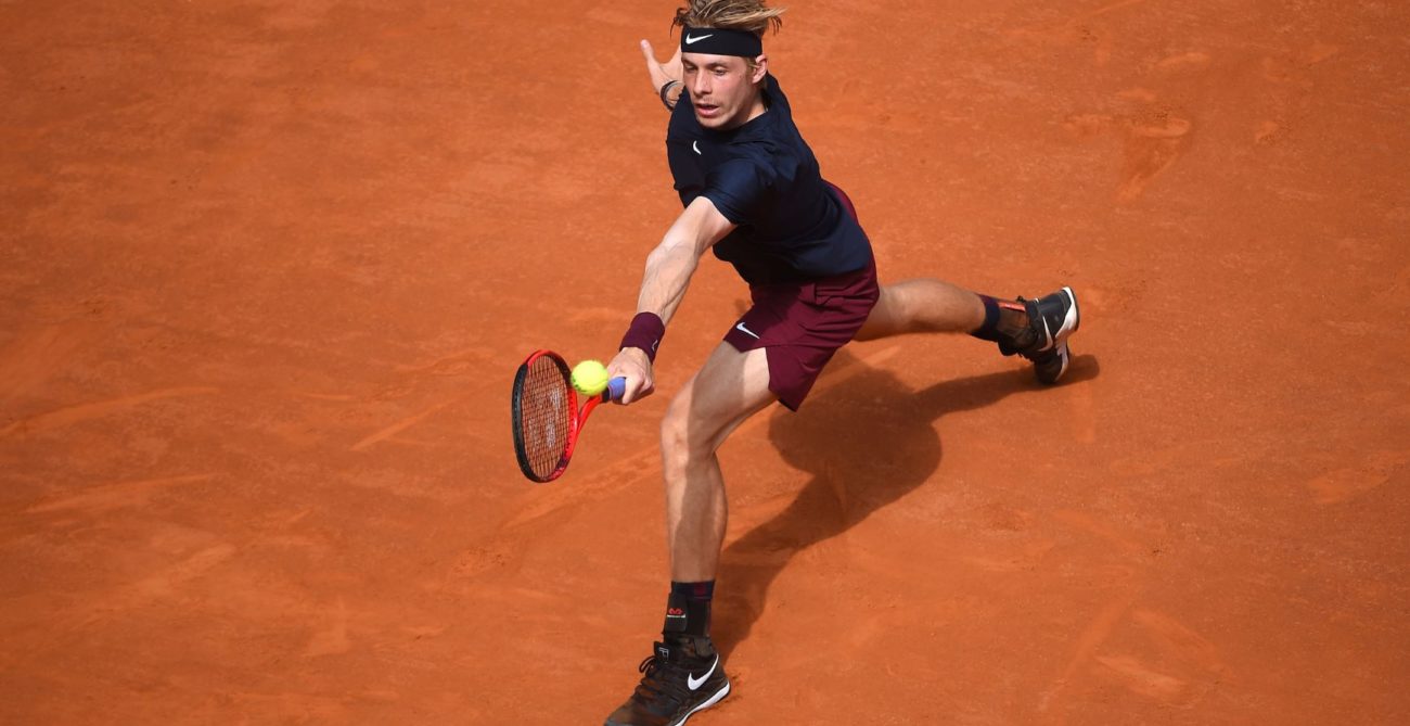 Denis Shapovalov stretches to hit a backhand