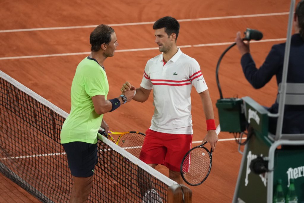 Novak Djokovic and Rafael Nadal shake hands at the net after their semi-final match