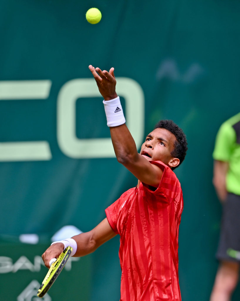 Felix tosses the ball for a serve