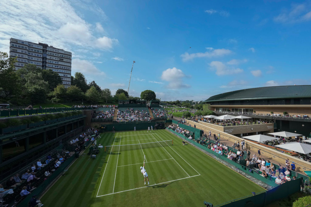 Top view of a Wimbledon court with players in action