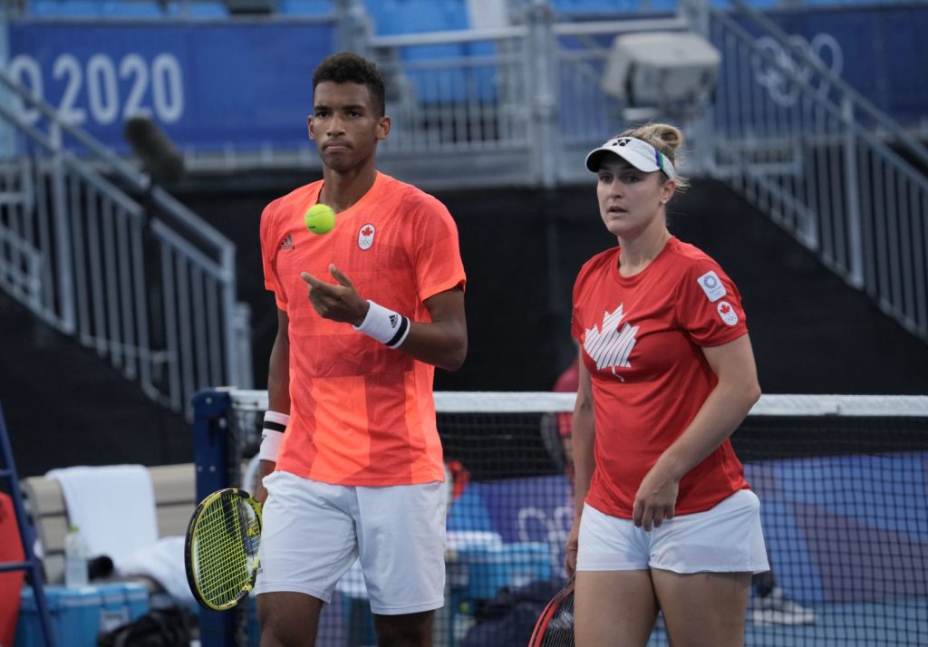 Felix Auger-Aliassime and Gabriela Dabrowski standing next to each other on court