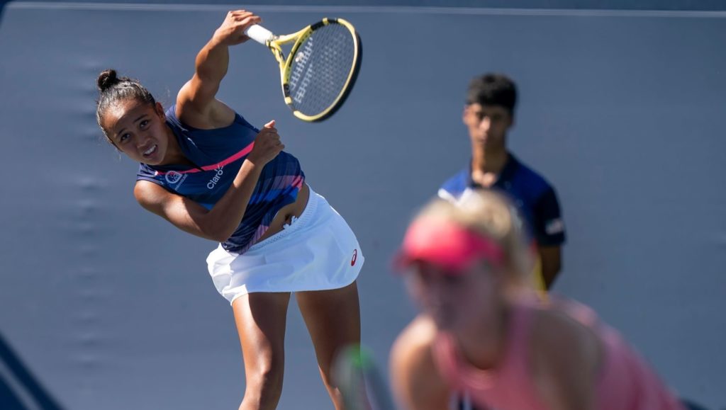 Fernandez serving partner Routcliffe at net