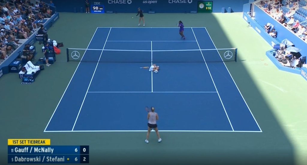 Dabrowski and Stafani on court, Stefani on the ground holding her knee