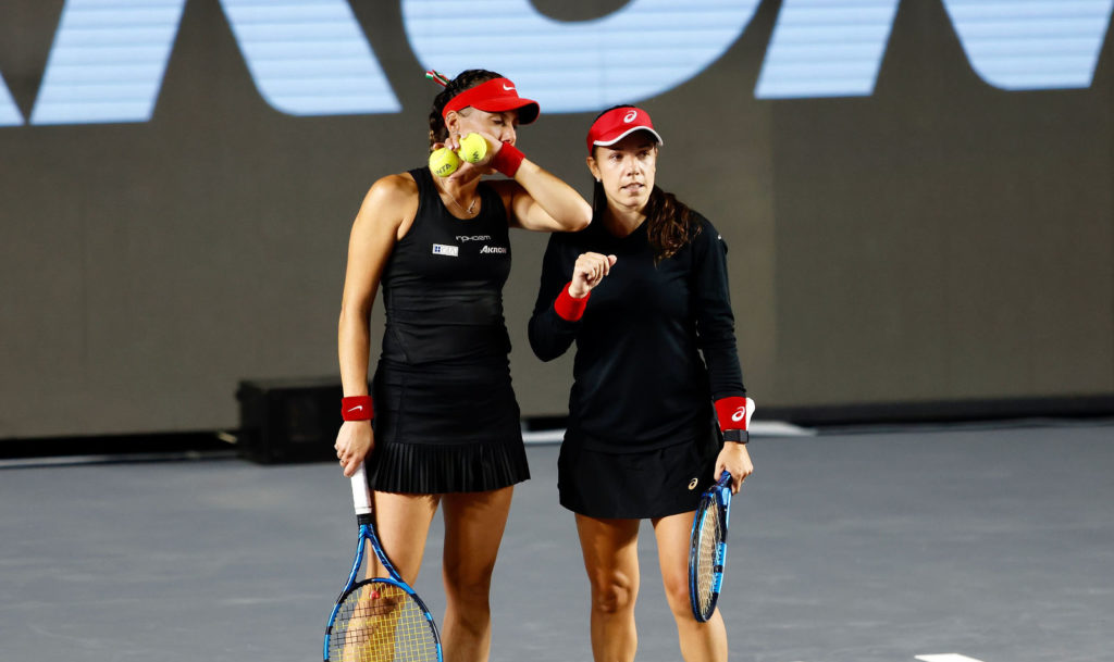 Giuliana Olmos and Sharon Fichman talk during a match.