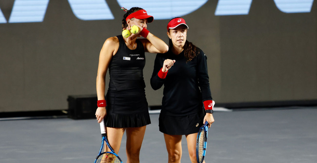 Giuliana Olmos and Sharon Fichman talk during a match.