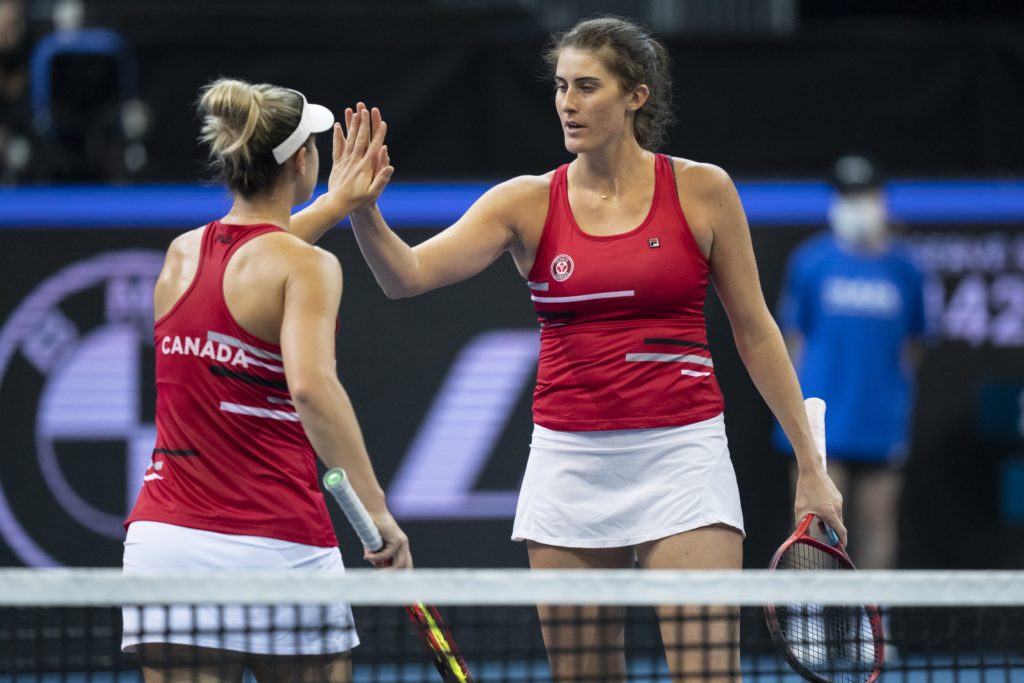 Gabriela Dabrowski and Rebecca Marino high five.