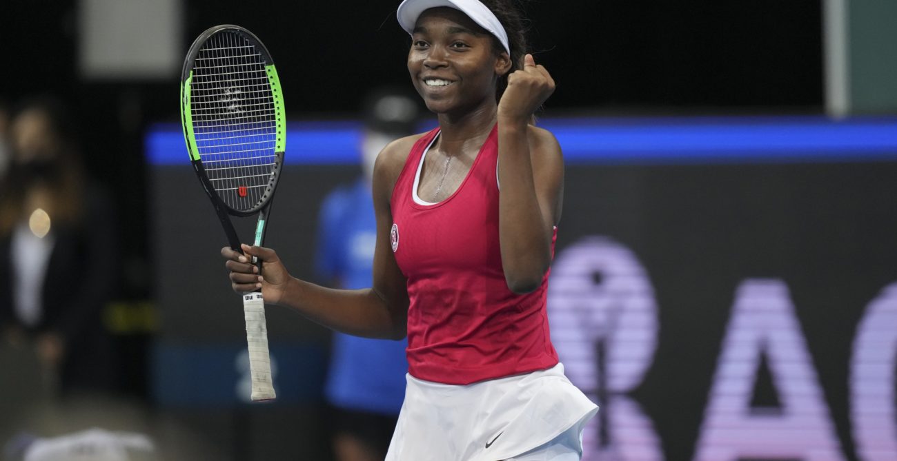 Francoise Abanda pumps her fist and smiles.