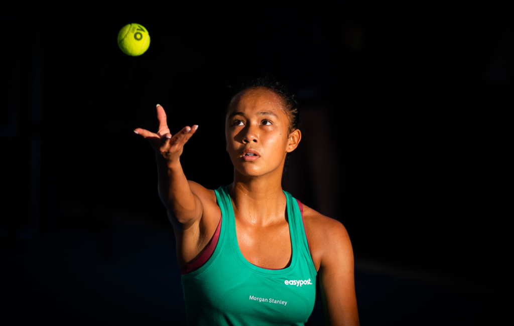 Leylah Fernandez tosses up a ball to serve.