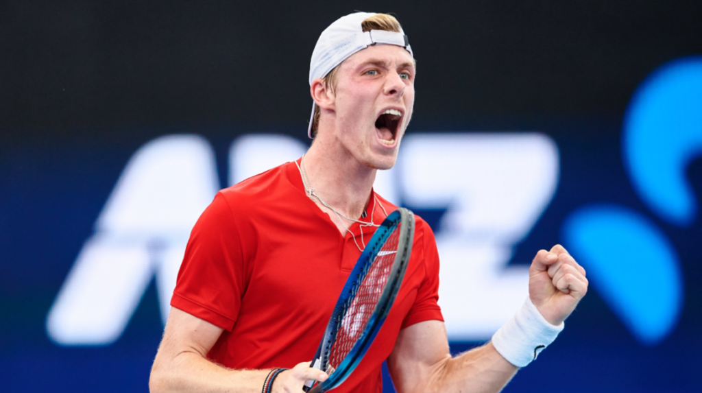 Denis Shapovalov pumps his fist and yells