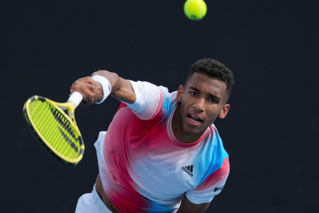 felix auger-aliassime hits volley at the australian open