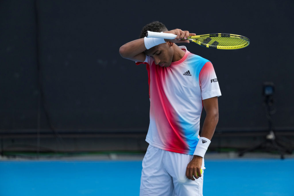 Felix Auger-Aliassime wipes his forehand