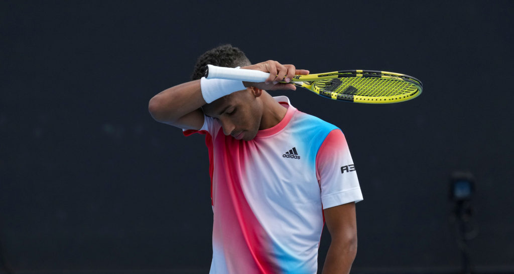 Felix Auger-Aliassime wipes his forehand