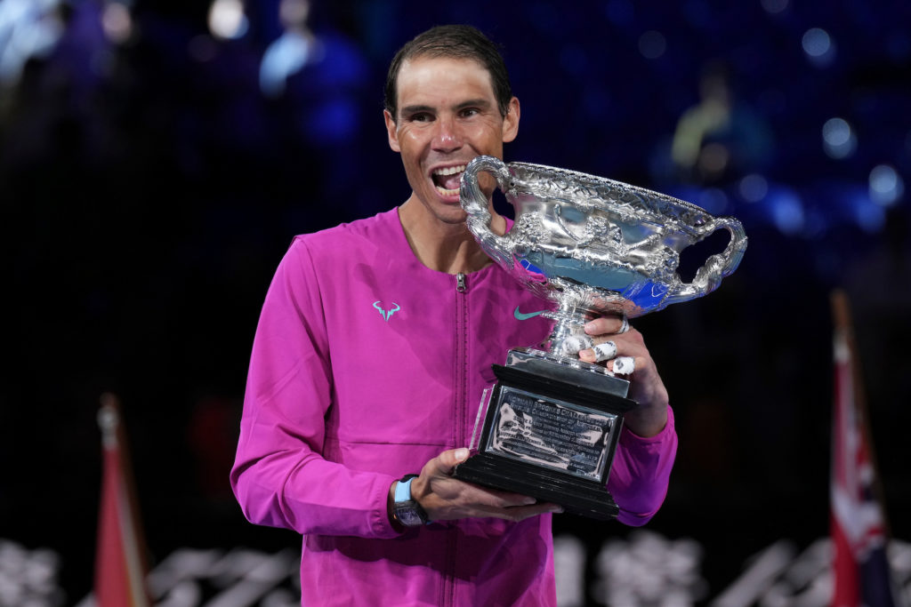 Rafael Nadal bites the trophy.