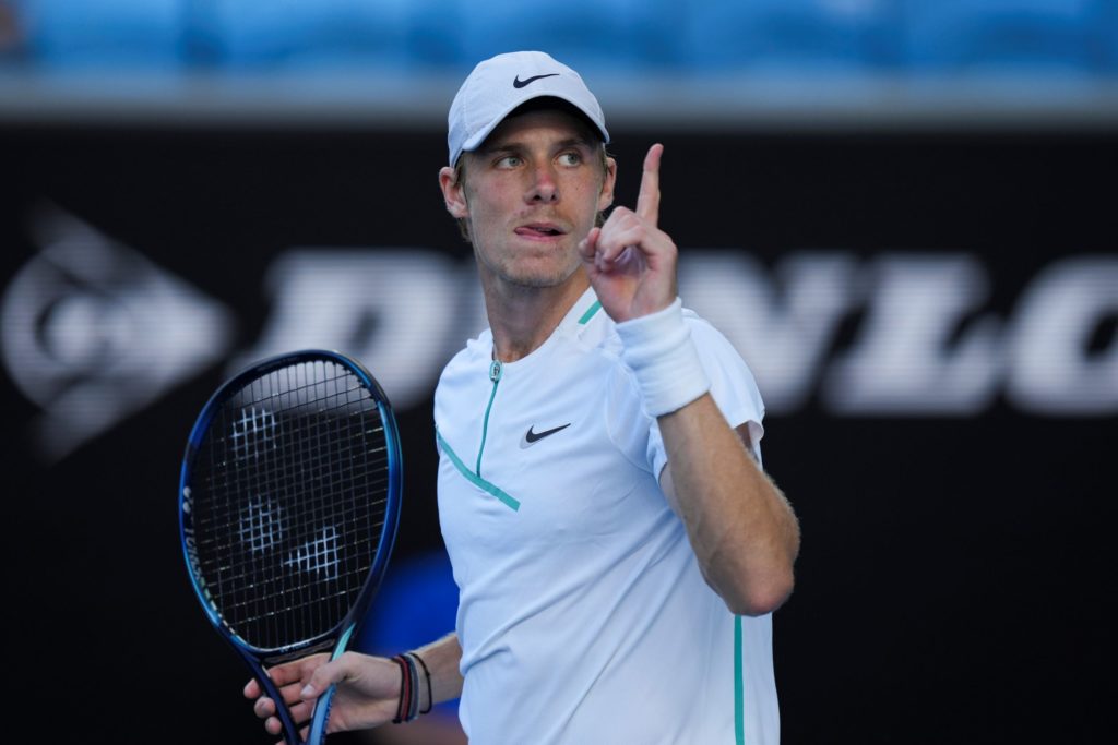 denis shapovalov holds up his finger after win