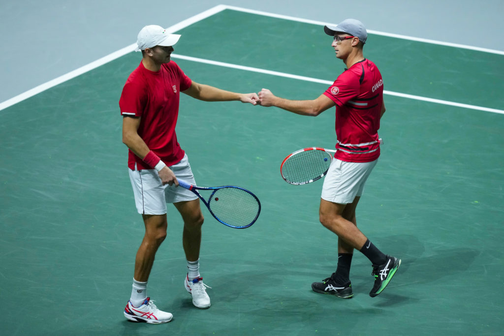 Brayden Schur and Peter Polansky fist bump.