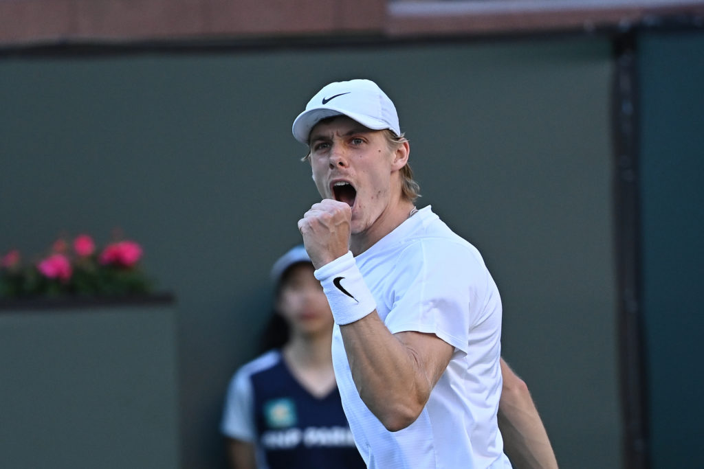 Denis Shapovalov pumps his fist and yells.