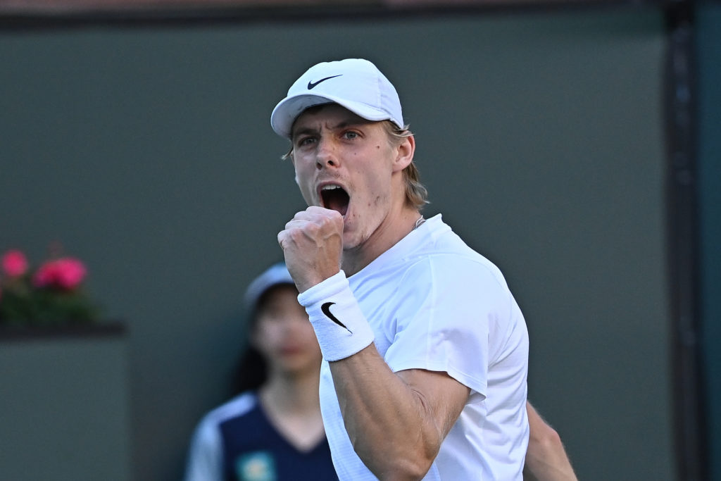 Denis Shapovalov pumps his fist and yells.