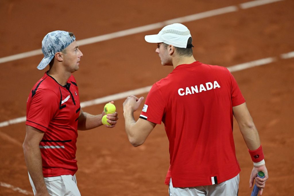 Peter Polansky and Brayden Schnur talk on court.