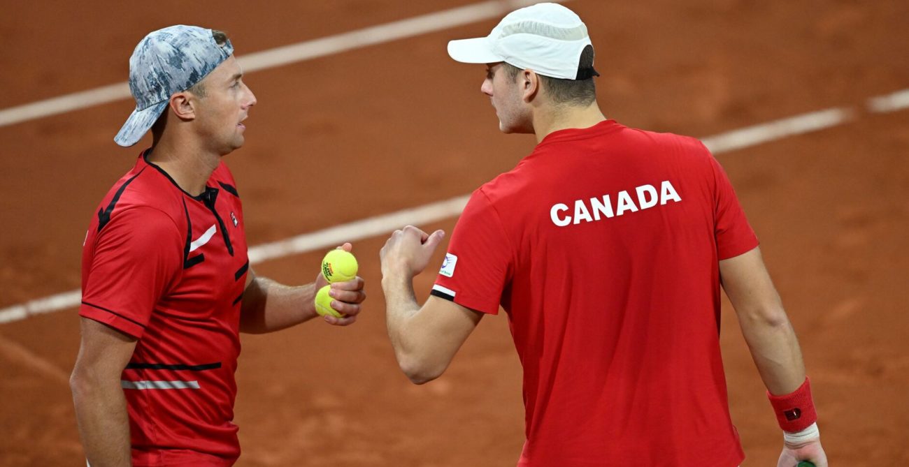 Peter Polansky and Brayden Schnur talk on court.