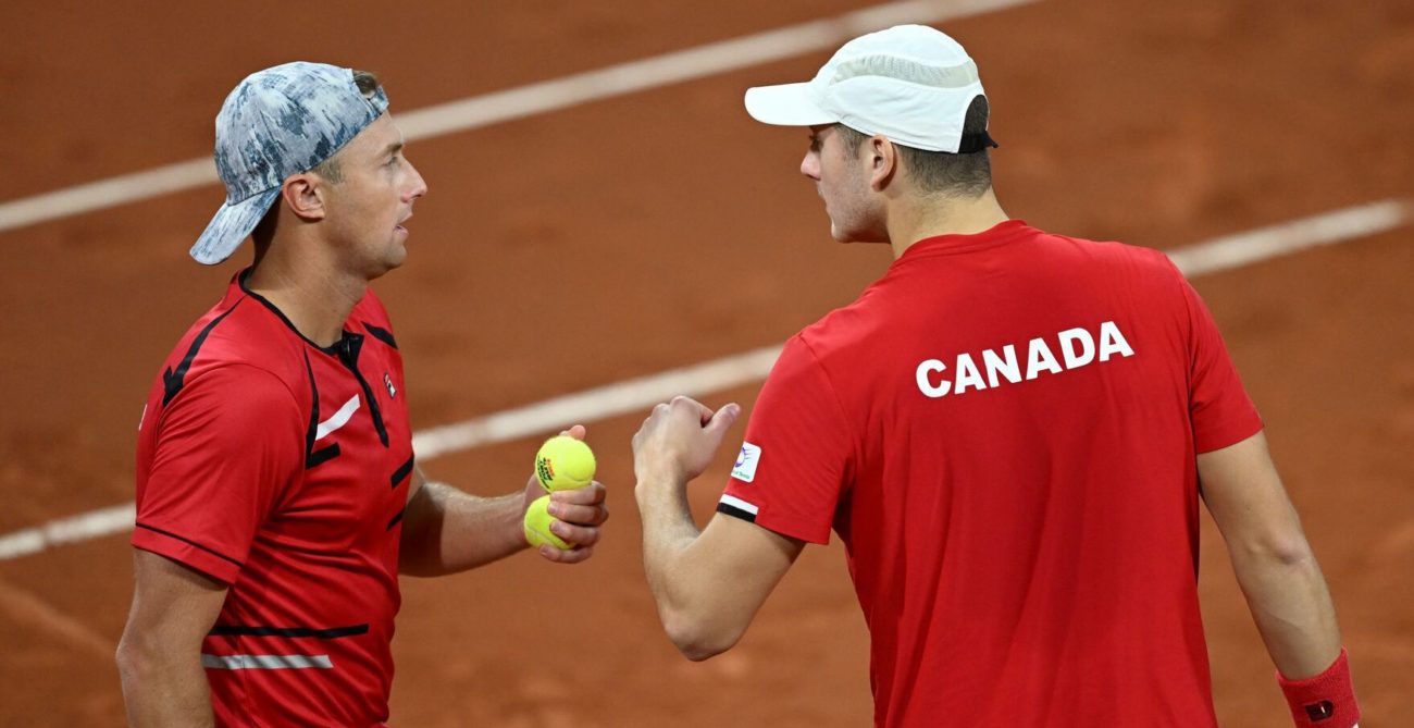 Peter Polansky and Brayden Schnur talk on court.