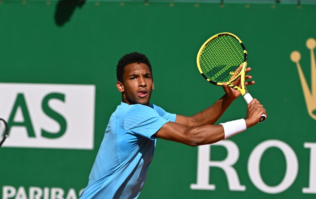 Felix Auger-Aliassime prepares to hit a backhand volley