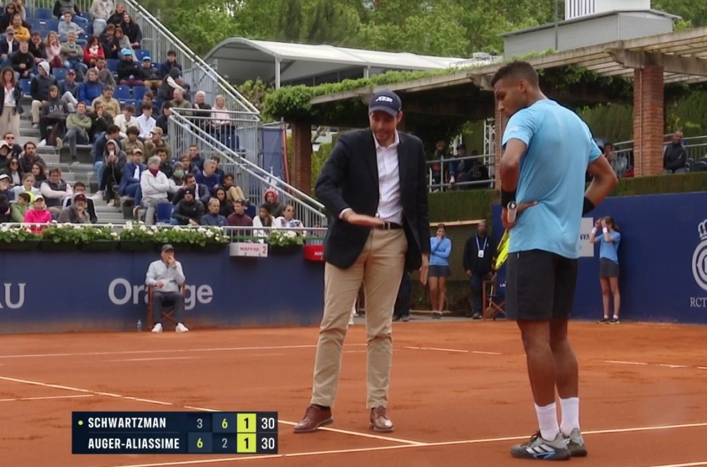 Felix checking a ball mark on clay
