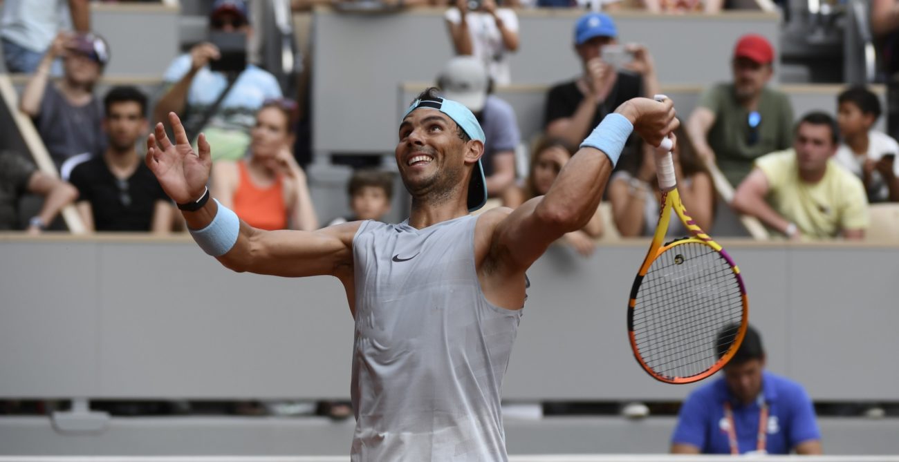 Rafael Nadal hits a ball into the crowd.