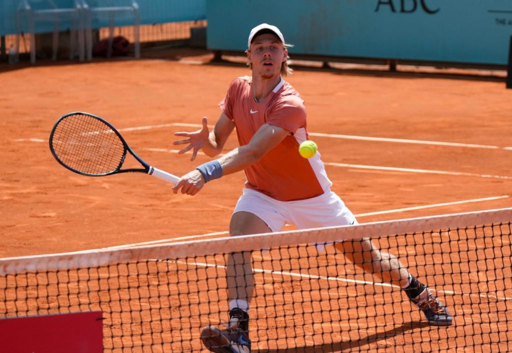 Denis Shapovalov hits a backhand at the net.