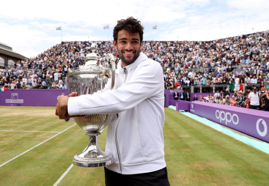 Matteo Berrettini hugs the Queens Club trophy.