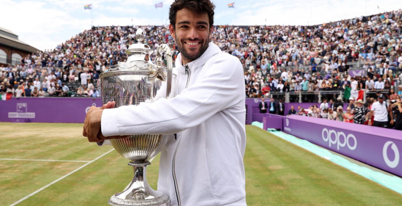 Matteo Berrettini hugs the Queens Club trophy.