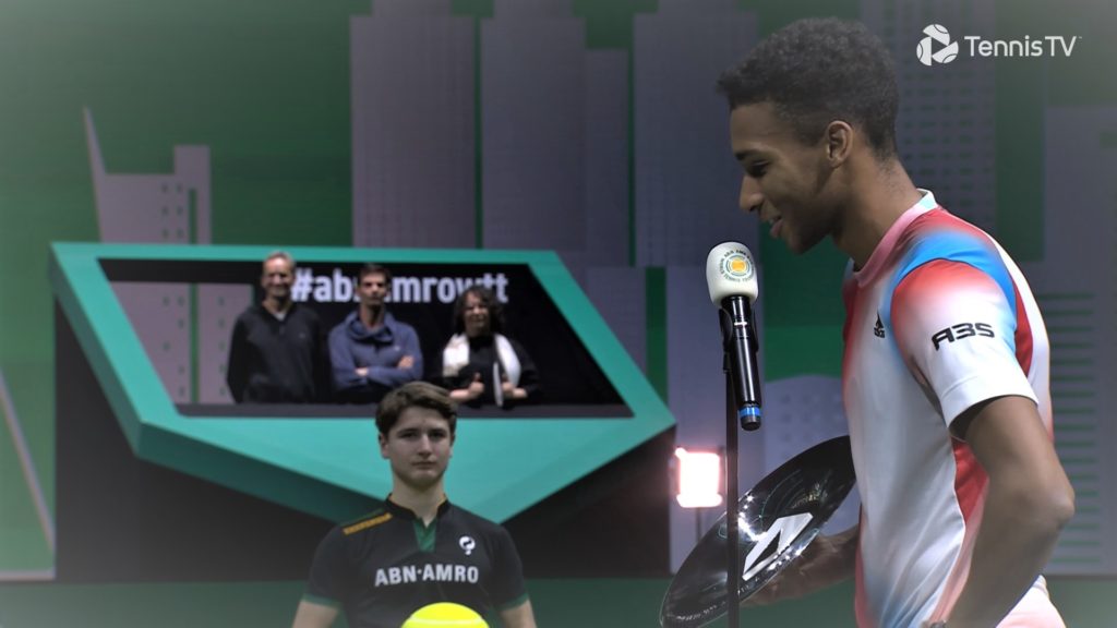Felix Auger-Aliassime talks into the microphone in an on-court interview