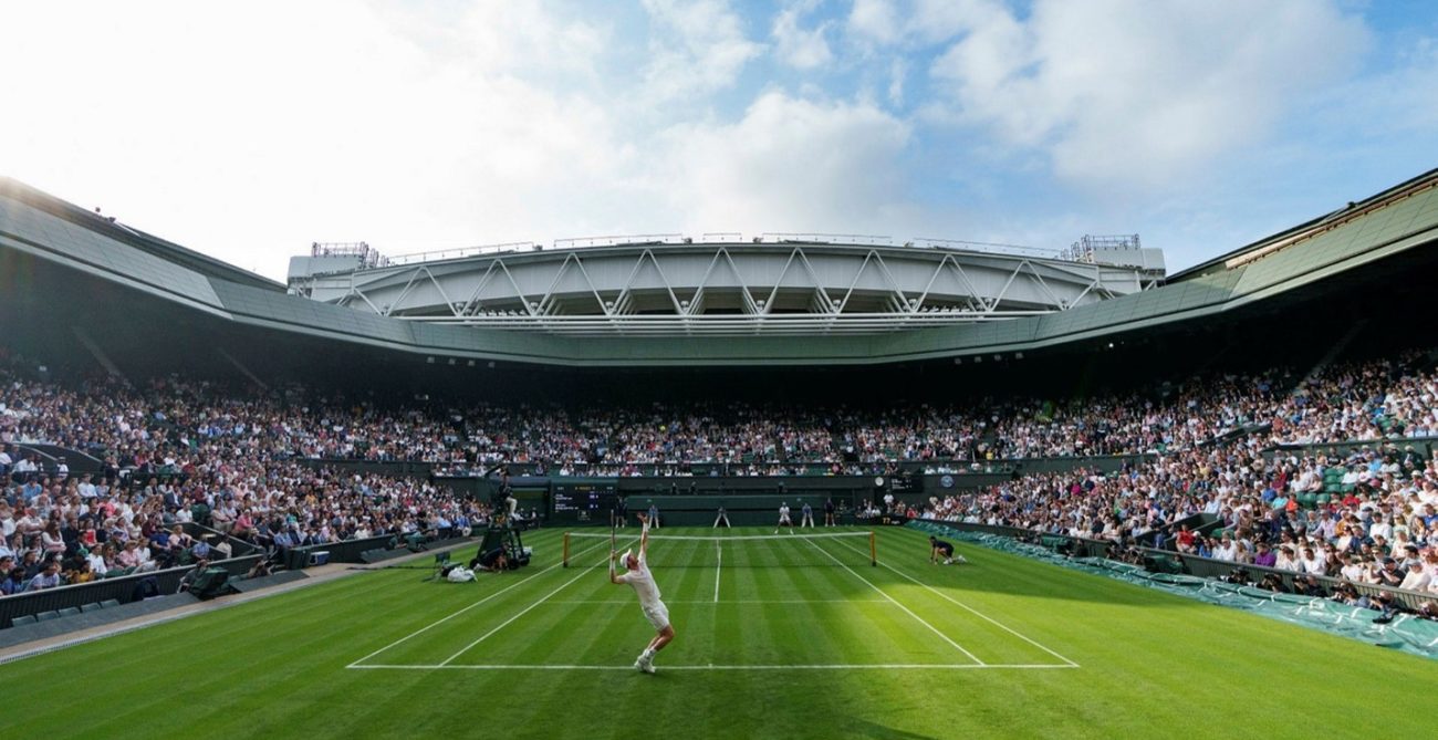 Male player serving on Centre Court