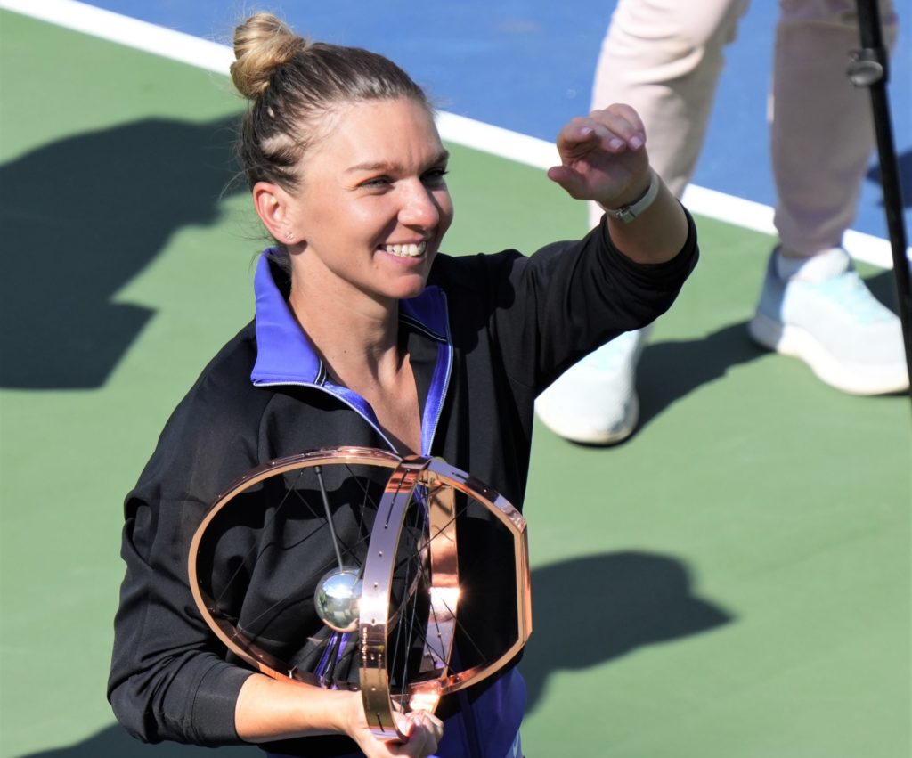 Simona Halep holds the singles trophy.