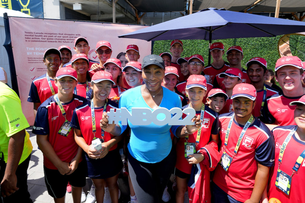 Serena Williams poses for a photo with the ball crew.