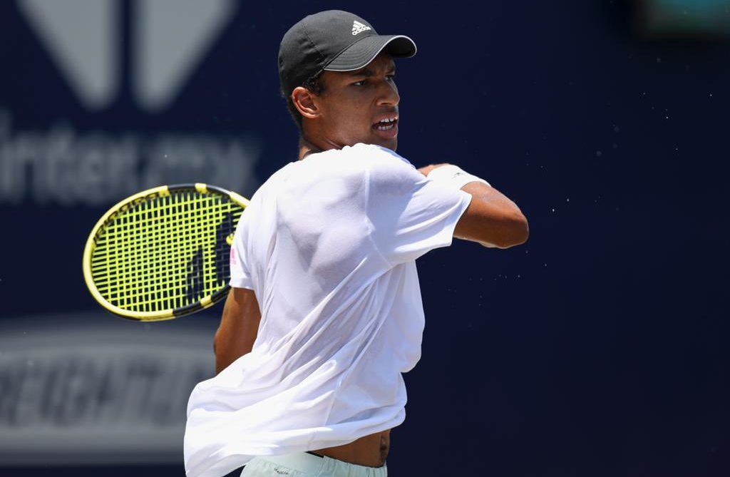 Felix Auger-Aliassime follows through on a forehand.