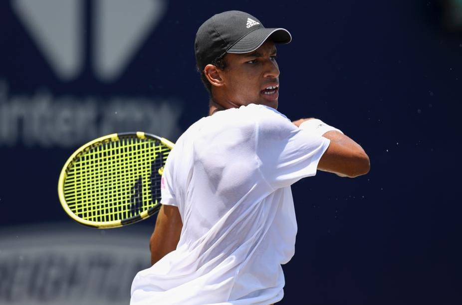 Felix Auger-Aliassime follows through on a forehand.