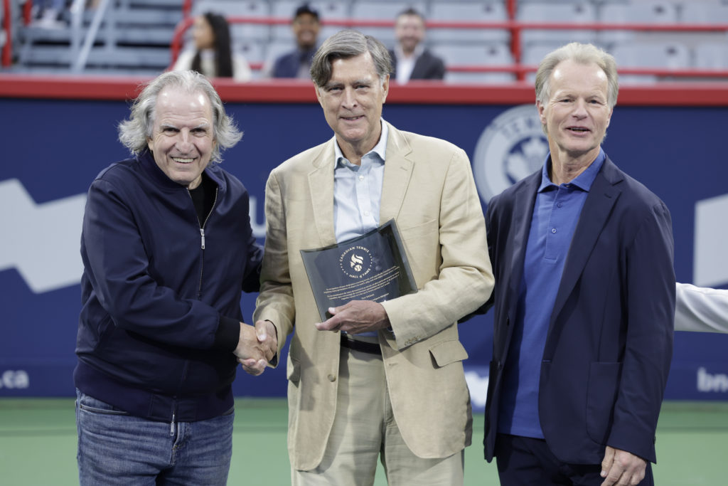Tom Tebbett shakes hands during his Tennis Canada Hall of Fame induction.