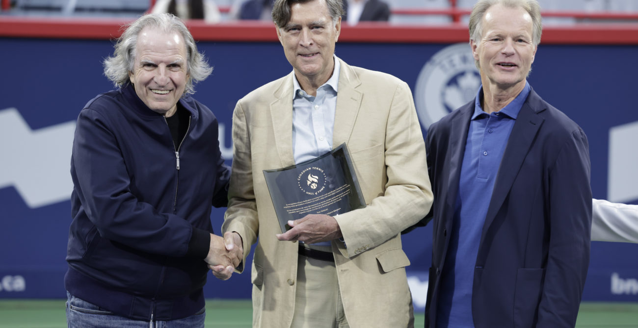 Tom Tebbett shakes hands during his Tennis Canada Hall of Fame induction.