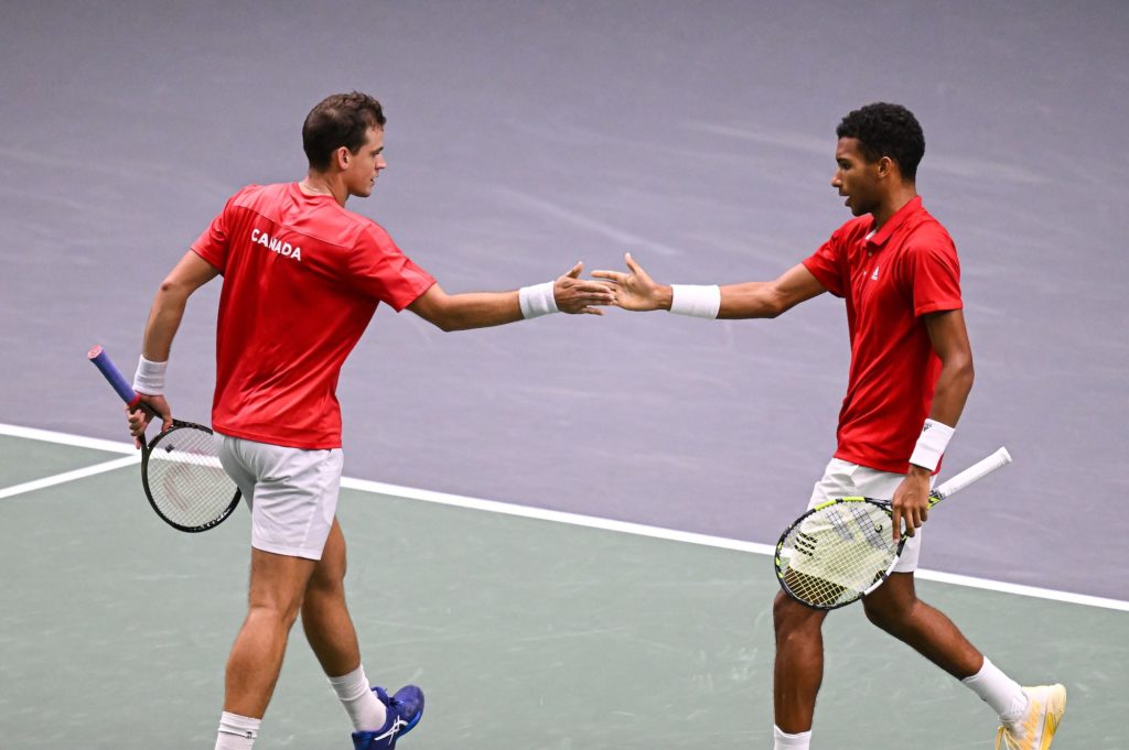 Vasek Pospisil (left) and Felix Auger-Aliassime high-five