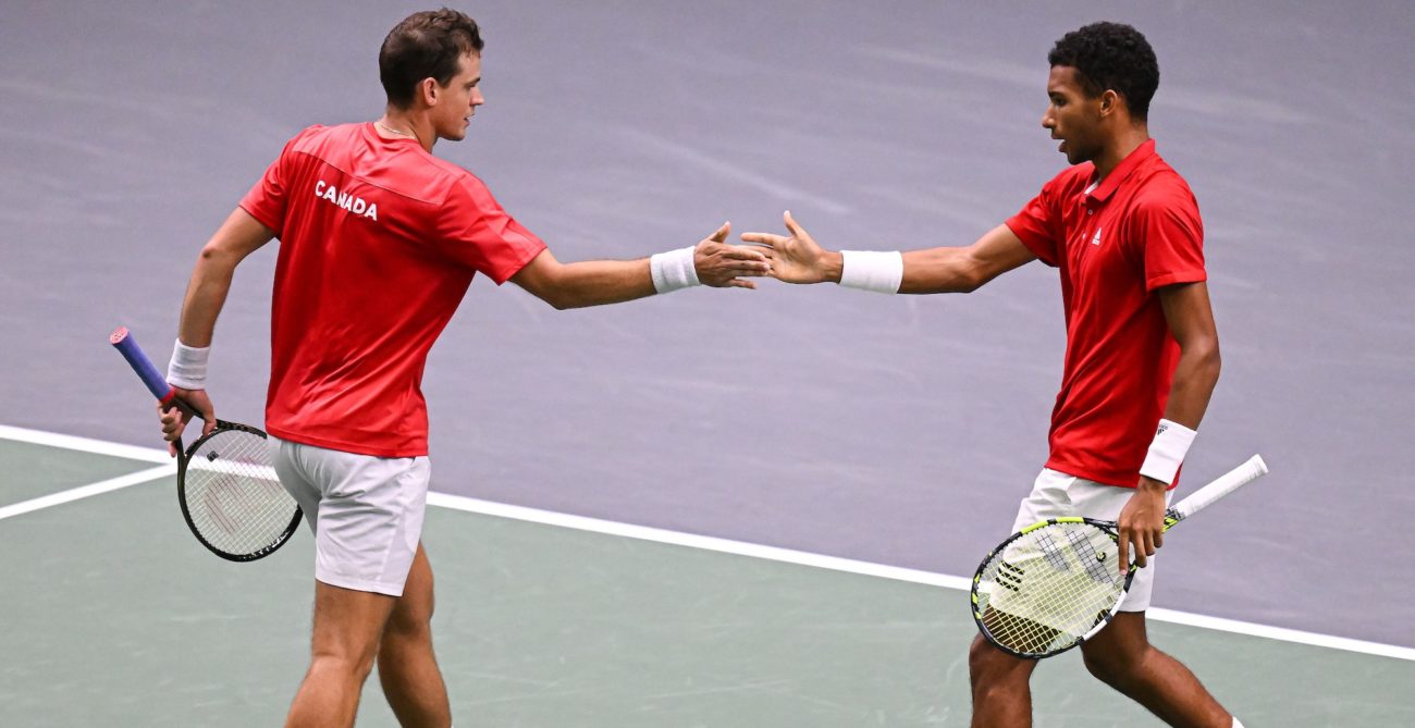 Vasek Pospisil (left) and Felix Auger-Aliassime high-five
