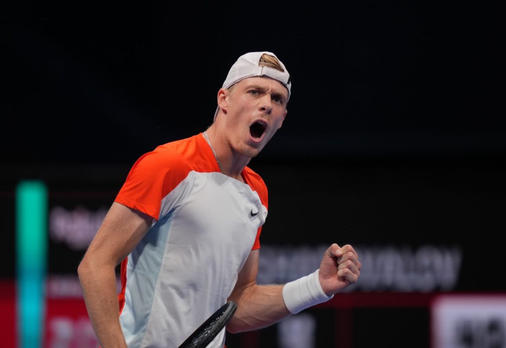 Denis Shapovalov pumps his fist and yells.