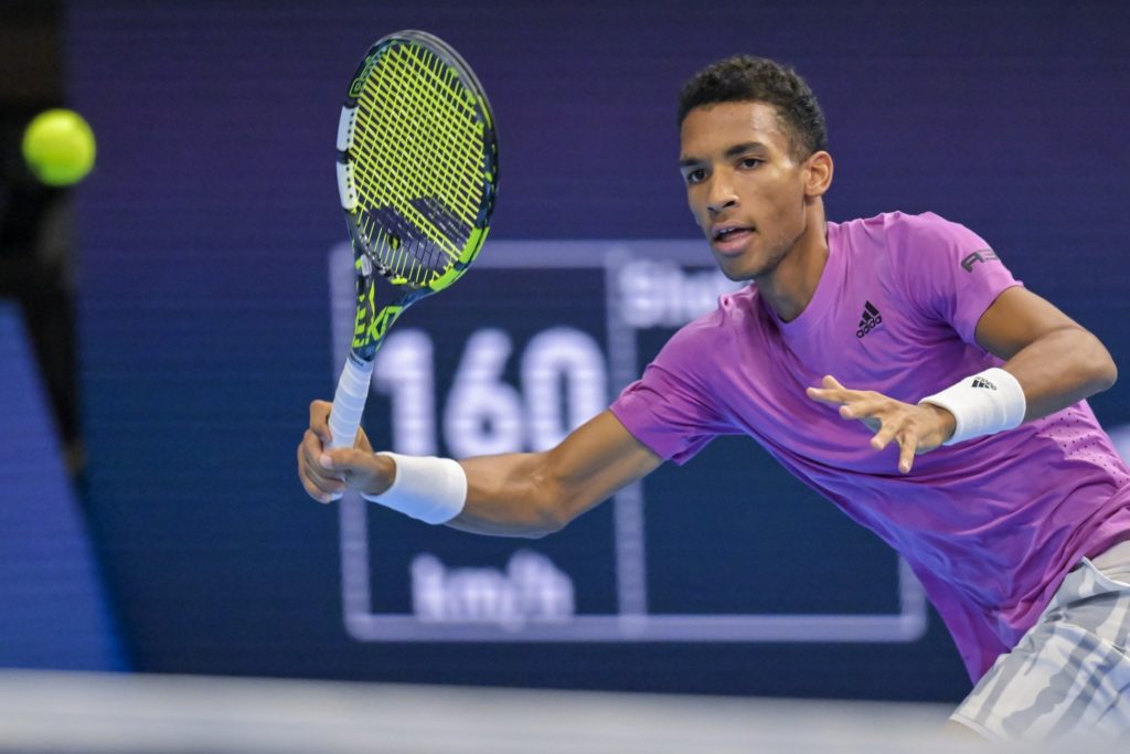 Felix Auger-Aliassime winds up for a forehand.